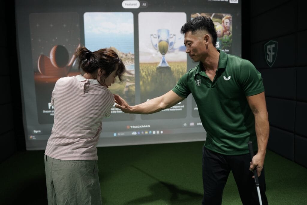 beginner golfer learning grip during intro lesson in Dubai